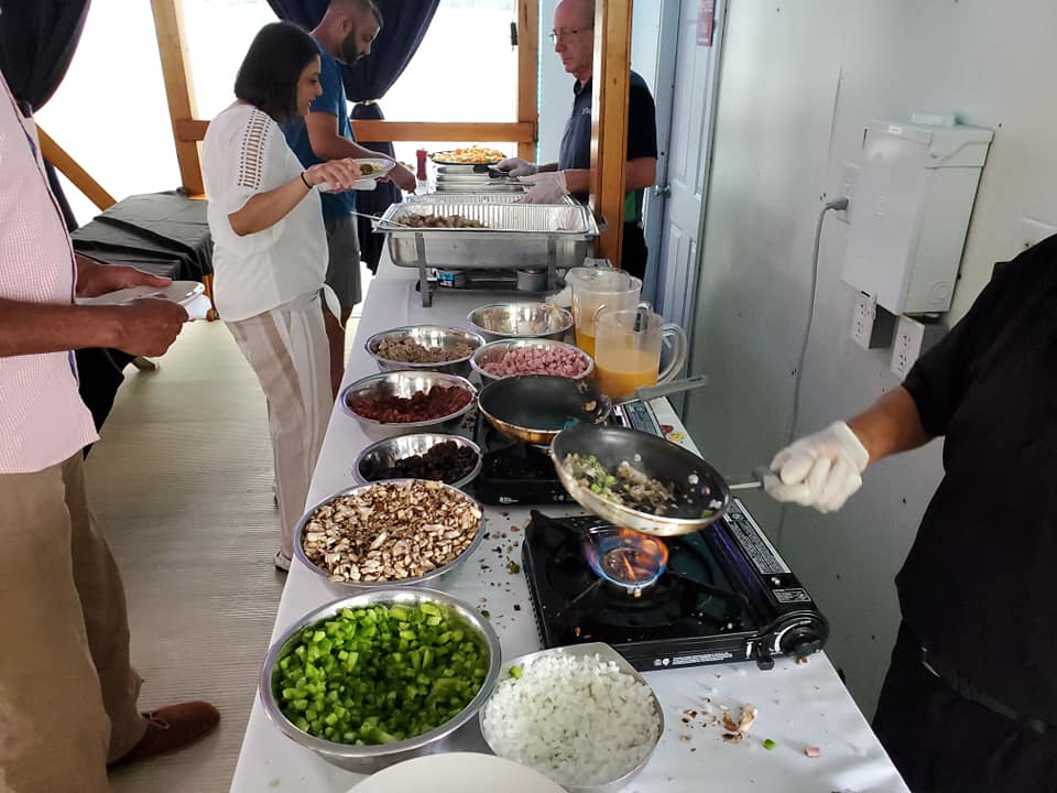Brunch with Omelet Bar a person standing in a kitchen preparing food
