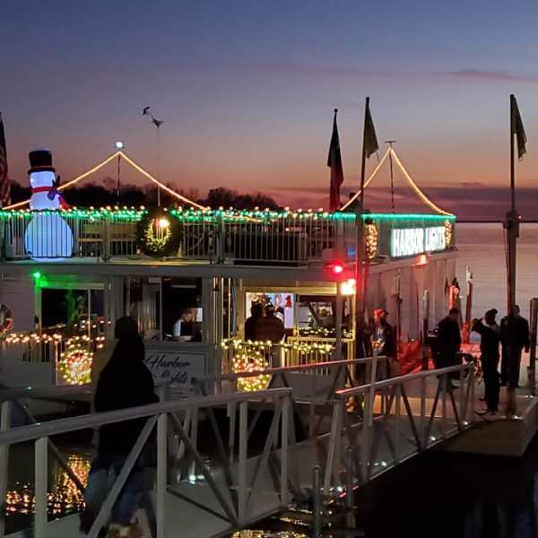 a group of people on a dock next to a body of water