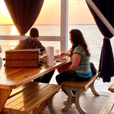 a woman sitting at a picnic table