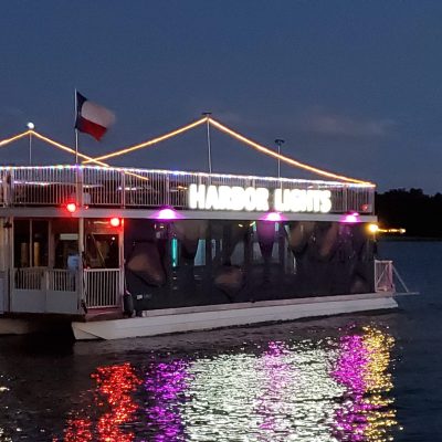 a boat floating along a river next to a body of water