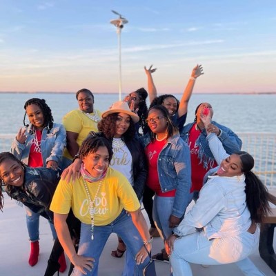 a group of people standing next to a body of water