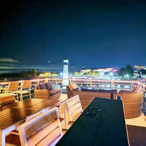 a group of people sitting at a dock