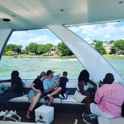 a group of people sitting on a boat in the water