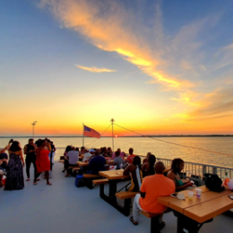 a group of people sitting at a beach